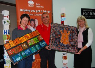 RDANI Project Officer, Kim-Trieste Hastings, New England’s Aboriginal Customer Service Officer with Fair Trading, Brett Cunningham, and Armidale Fair Trading Centre Manager, Sally-Anne Burrow with artwork entered by local Armidale artist, Elizabeth Ervine and grade 5 students from the Armidale City Public School.